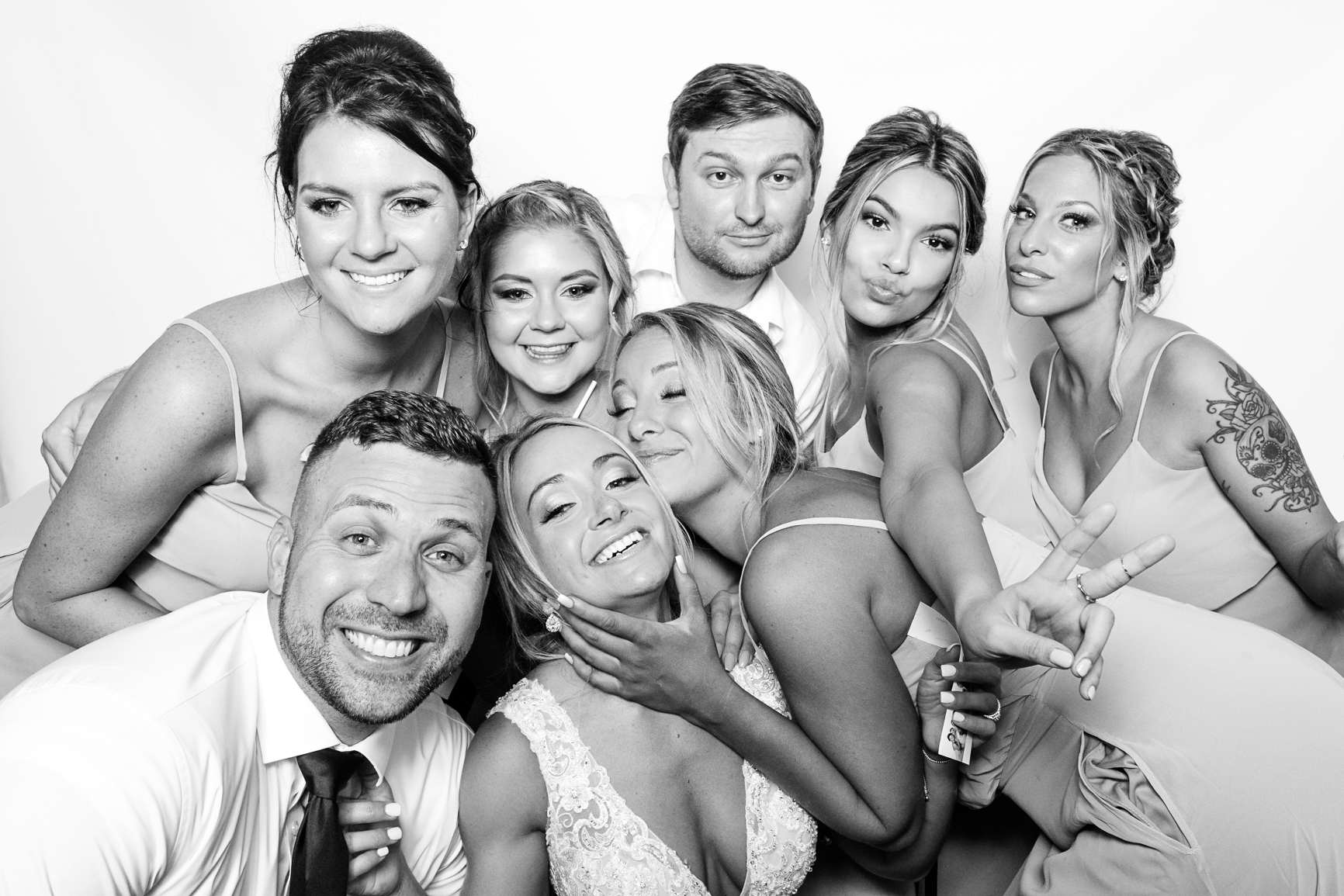 Wedding party laughing together inside the Glam photo booth